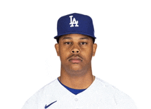 a baseball player wearing a la hat and white jersey