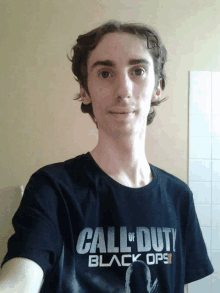 a young man is wearing a black call of duty black ops ii shirt