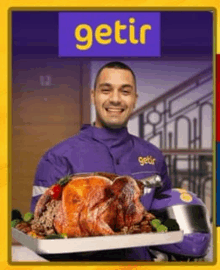 a man in a purple jacket is holding a tray of food in front of a sign that says " getir "