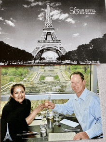 a man and a woman are toasting in front of the eiffel tower at the 58ur eiffel restaurant