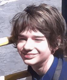 a close up of a young boy 's face smiling