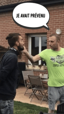 a man wearing a green shirt that says super hot is being punched by another man