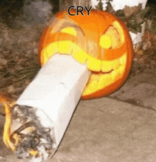 a pumpkin carved to look like a cigarette has the word cry written on it