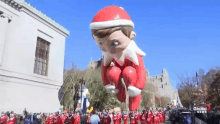 a parade with a balloon that says global news on the bottom