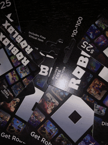 a bunch of roblox gift cards are on a table