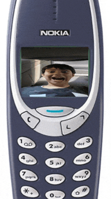 a nokia cellphone with a picture of a man on the screen