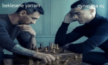 two men are playing a game of chess with the words beklesene yarram and oynasana oc on the bottom