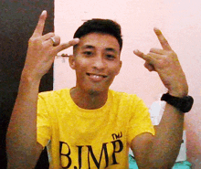 a man wearing a yellow shirt that says b.jmp on it