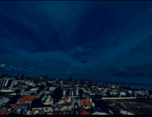 an aerial view of a city at night with a blue sky