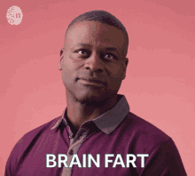 a man wearing a purple shirt has the word brain fart on his shirt