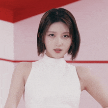 a woman with short hair is wearing a white turtleneck