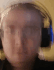 a blurry photo of a person wearing headphones