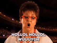 a woman wearing red glasses is singing hollol hollol wuuuuych