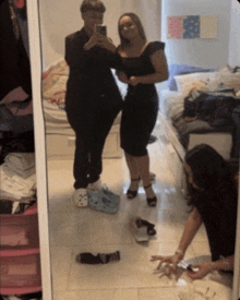 two women are taking a picture of themselves in a bedroom mirror