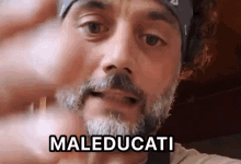 a man with a beard and a bandana on his head says maleducati