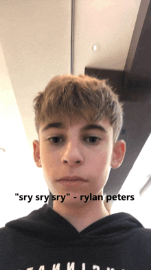 a young boy with the name rylan peters on his sweatshirt