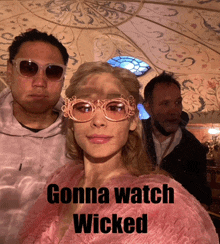 a woman wearing pink glasses with the words gonna watch wicked