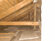 an attic with a brick wall and a wooden beam