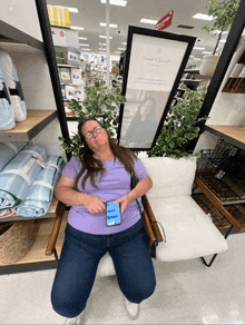 a woman is sitting in a chair in front of a sign that says simply southern