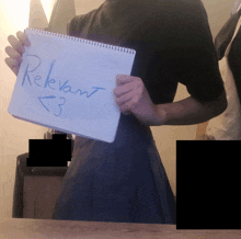 a person holding a piece of paper that says relevant < 3 on it