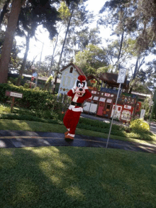 a person in a santa claus costume is walking down a path