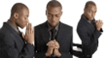 a man in a suit and tie is praying with his hands folded in prayer .