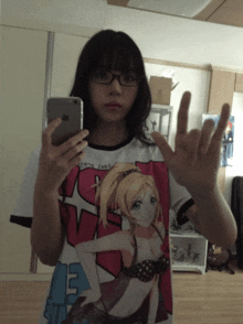 a girl taking a selfie with her phone and a shirt that says ' ns ' on it