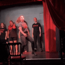 a group of people on a stage with one wearing a t-shirt that says netflix