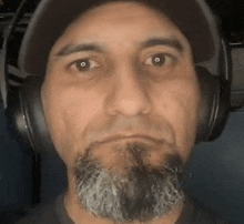 a man with a beard and headphones on his head .