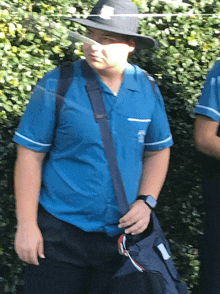 a man wearing a blue shirt that says ' nurse ' on the sleeve