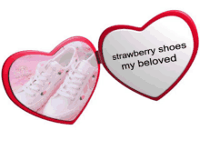 a pair of strawberry shoes sit inside a heart shaped mirror