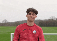 a young man wearing a red jersey with the number 30