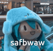 a stuffed animal wearing a blue hat with the words safbwaw written on it