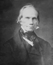 a black and white photo of a man in a suit and tie