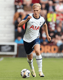 a soccer player wearing a white jersey with aia on it