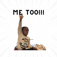 a young boy raising his hand in front of a sign that says " me too "