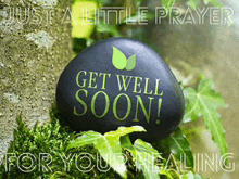 a black stone with the words get well soon on it