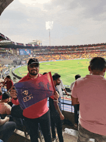 a man holds up a flag that says bd7 on it