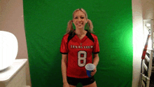 a woman wearing a texas tech jersey with the number 8