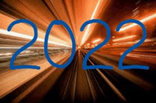 the year 2022 is written on a blurry picture of a tunnel .