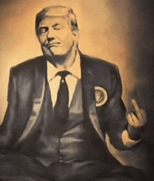 a man in a suit and tie is sitting in a lotus position and giving the middle finger