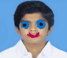 a boy with a smiley face drawn on his face and blue eyes