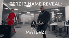 a man dancing in an office with the words terz13 name reveal