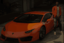 a man in an orange jacket stands next to a bright orange sports car