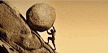 a man is pushing a large rock up a cliff .