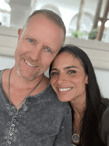 a man and a woman are posing for a picture together