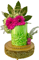 a green cake with pink flowers and a happy birthday plaque