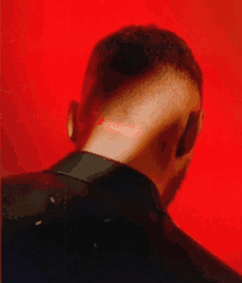 a close up of a man 's neck with a red light shining on it