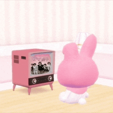 a pink rabbit is sitting in front of a pink tv