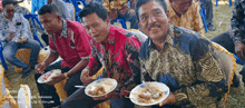 a group of men are sitting in chairs eating food from plates sponsored by tecno